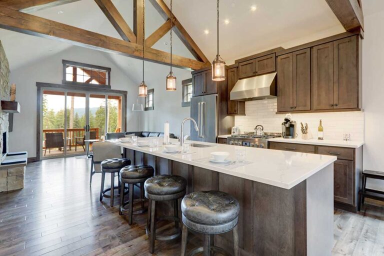A couple reviews a rental agreement and home purchase documents at a kitchen table.